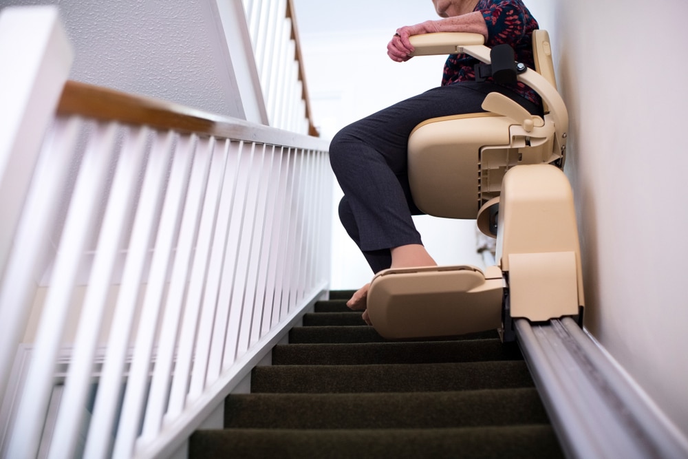 Detail,Of,Senior,Woman,Sitting,On,Stair,Lift,At,Home